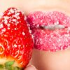 Woman’s mouth with strawberry